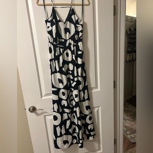 V-neck cut in front and back. Black and white.